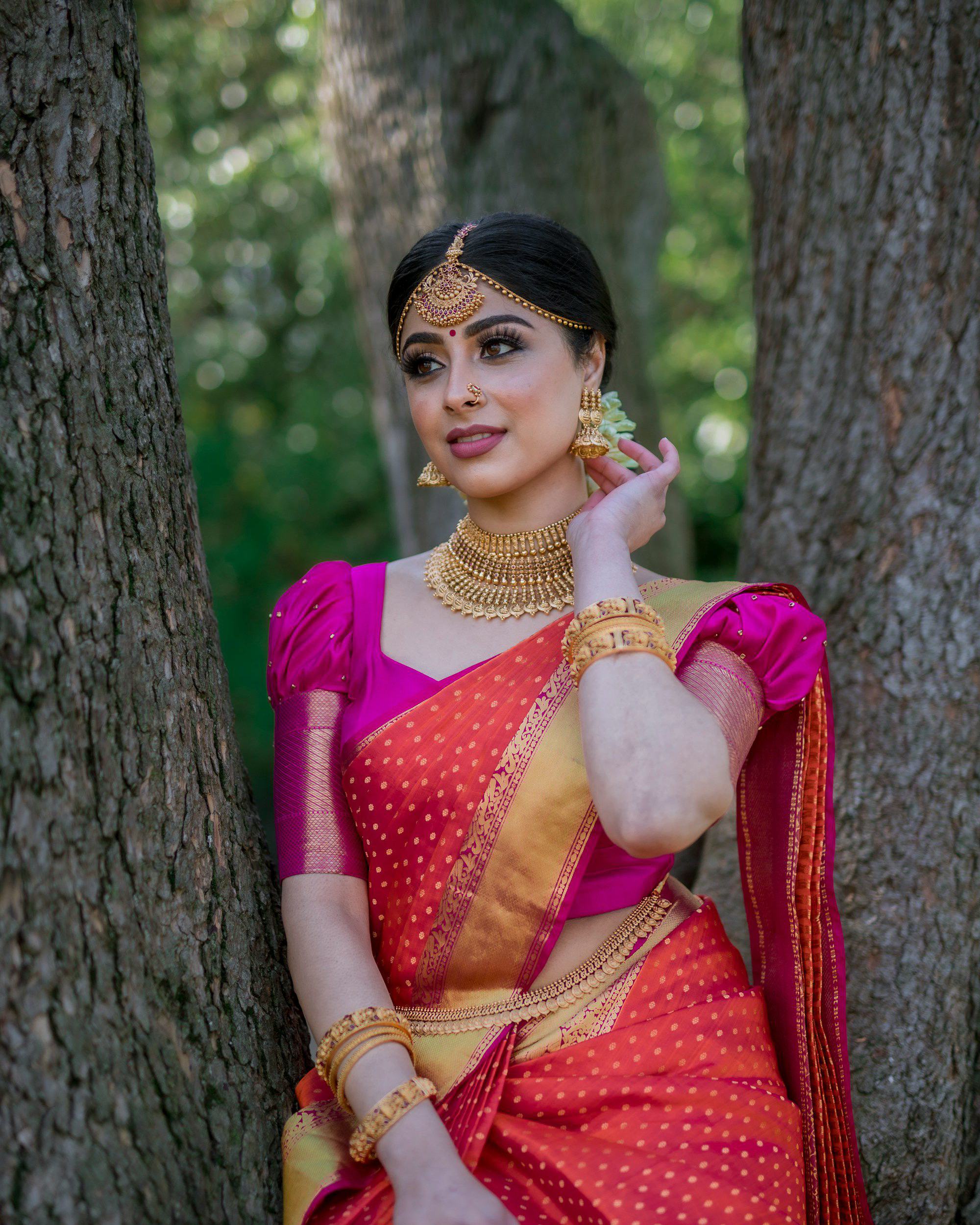 Model in pink saree with gold bridal jewellery