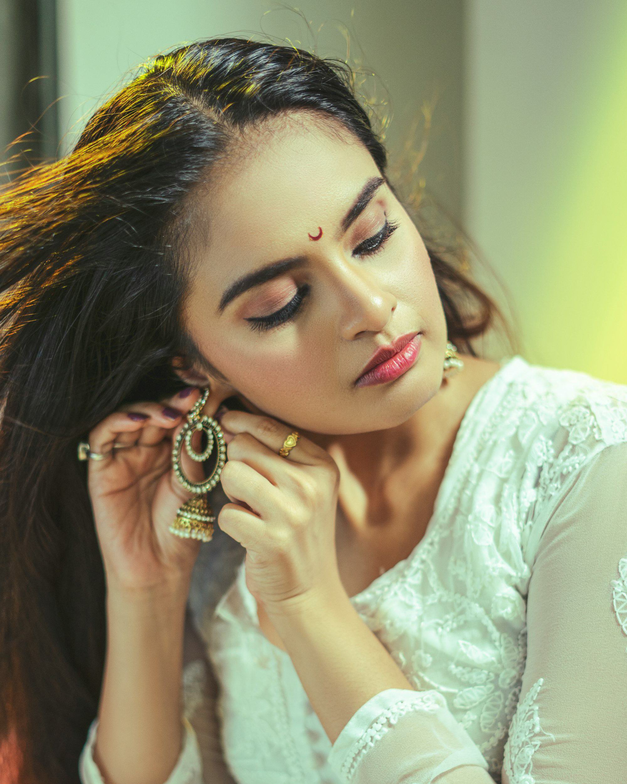 Model in white chikankari kurta with jhumka earrings